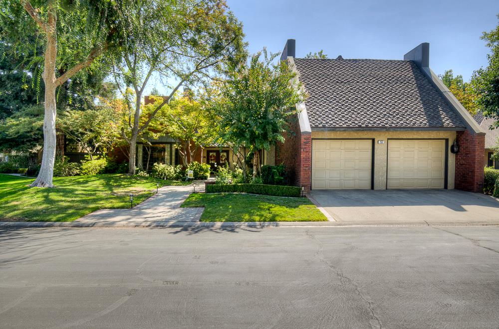 2555 West Bluff Avenue, Unit 152 Fresno, CA 93711 - Photo 44 of 45 a house with a yard and a trees