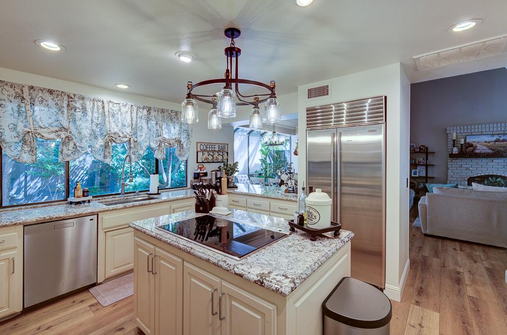 2555 West Bluff Avenue, Unit 152 Fresno, CA 93711 - Photo 5 of 45 a kitchen with sink refrigerator and microwave