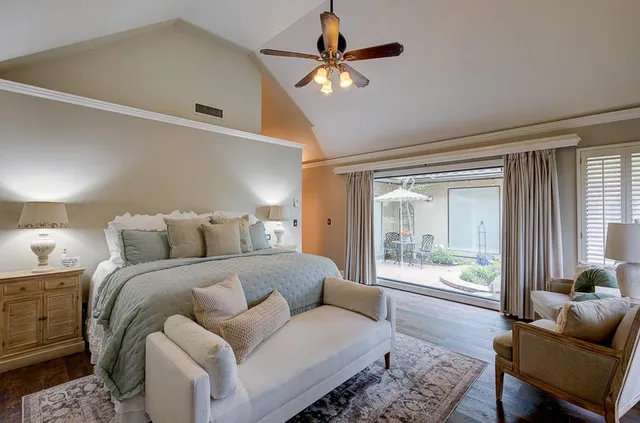 a bed room with a bed and a large window