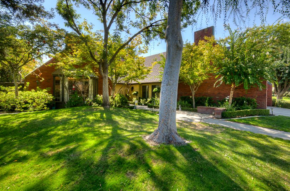 2555 West Bluff Avenue, Unit 152 Fresno, CA 93711 - Photo 8 of 45 a view of a house with a tree in a yard