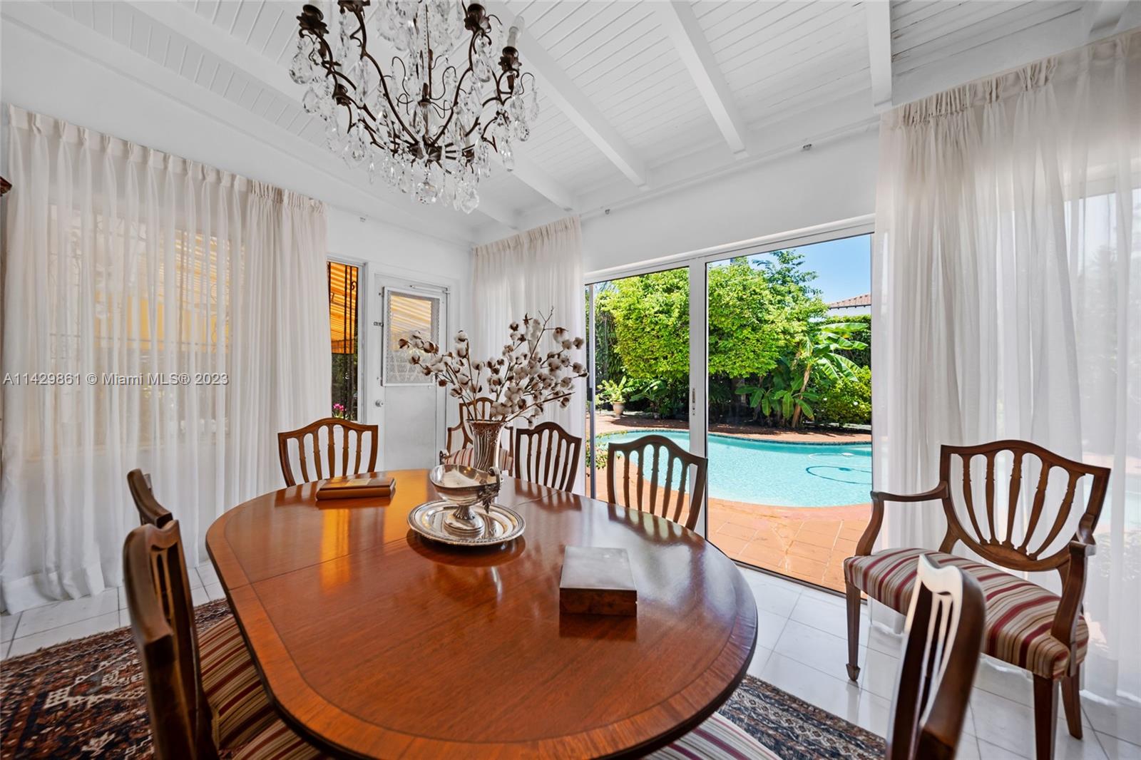 2935 North Bay Road Miami Beach, FL 33140 - Photo 18 of 27 a view of a dining room with furniture window and outside view