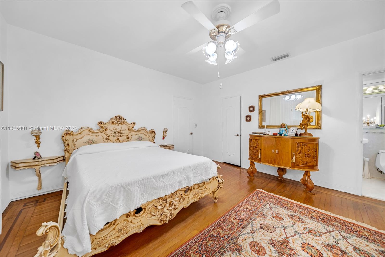2935 North Bay Road Miami Beach, FL 33140 - Photo 22 of 27 a bedroom with a bed and wooden floor