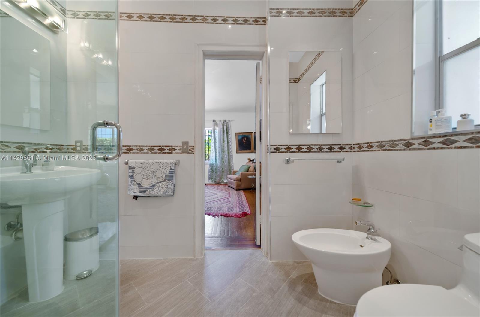 2935 North Bay Road Miami Beach, FL 33140 - Photo 25 of 27 a bathroom with a toilet sink and mirror