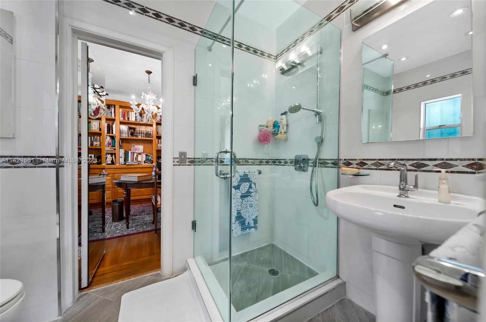 2935 North Bay Road Miami Beach, FL 33140 - Photo 27 of 27 a bathroom with a shower sink and mirror