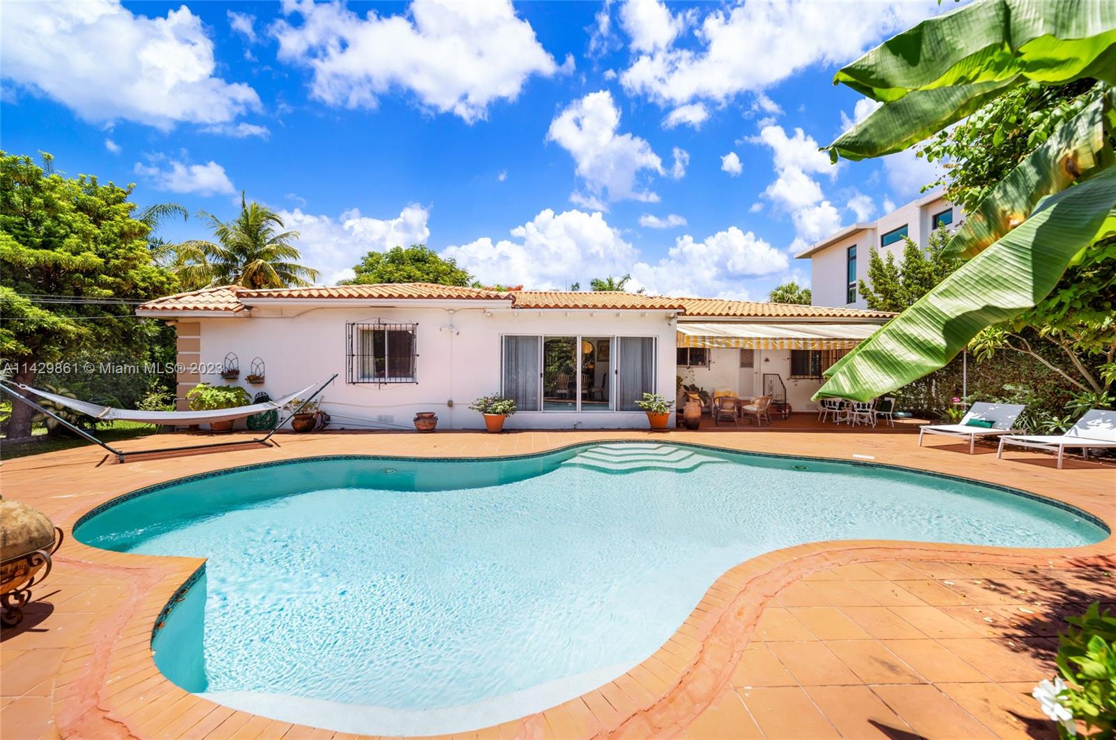 2935 North Bay Road Miami Beach, FL 33140 - Photo 10 of 27 a view of a house with swimming pool and sitting area
