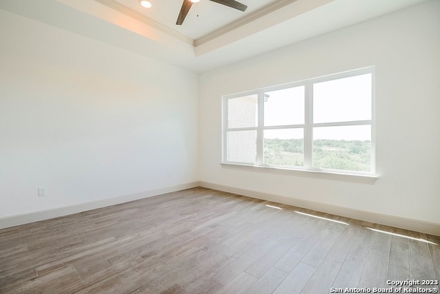 289 Star Grass, Unit B Spring Branch, TX 78070 - Photo 11 of 15 an empty room with wooden floor and windows