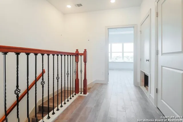 a view of hallway with wooden floor