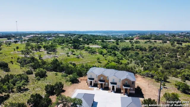 an aerial view of a house with a yard