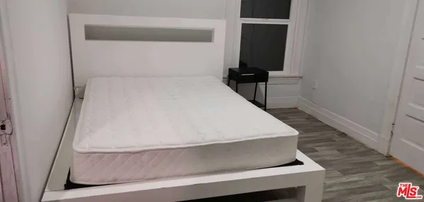 a bedroom with a bed and a table in it