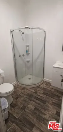 a bathroom with a toilet and a shower