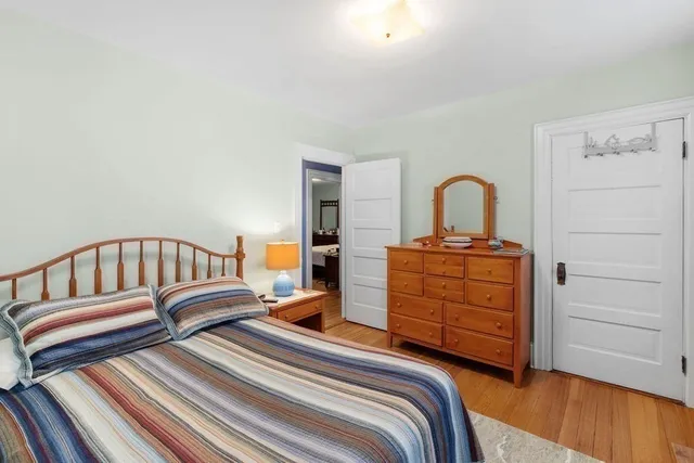 a bedroom with furniture and a large window