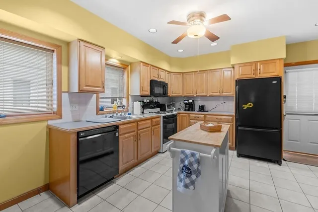 a kitchen with stainless steel appliances a refrigerator sink and microwave