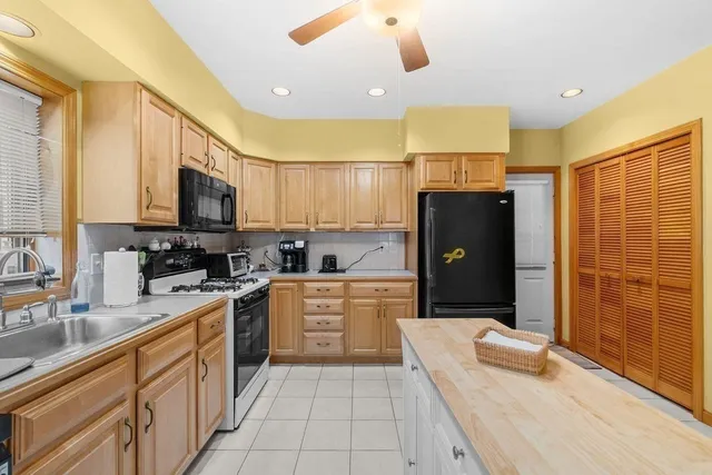 a kitchen with a sink stove and microwave