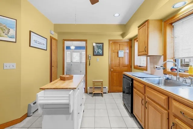 a dining room with furniture a chandelier and wooden floor