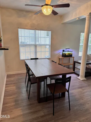 a view of a dining room with furniture and wooden floor