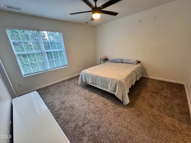 a bed sitting in a room next to a window