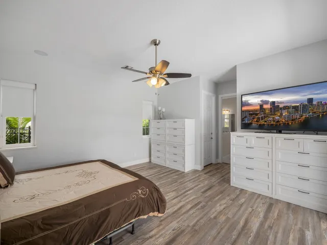 a bedroom with a bed and a flat screen tv