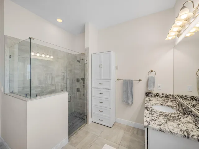 a bathroom with a shower and a sink