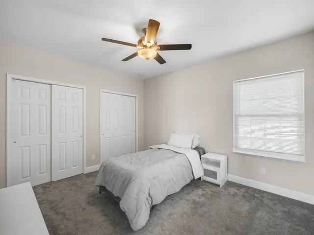 a utility room with dryer washer and a view of living room