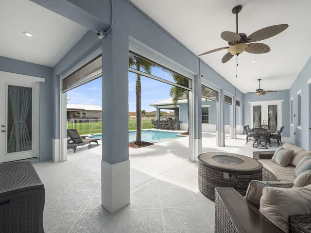 a front view of a house with swimming pool having outdoor seating