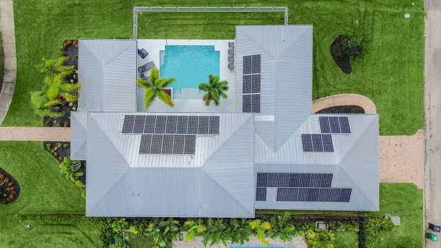 an aerial view of a house with garden space and street view