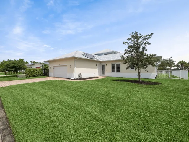 a view of an house with backyard space and garden