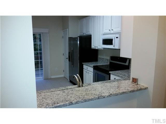 7663 Winners Edge Street Raleigh, NC 27617 - Photo 3 of 16 a kitchen with a refrigerator and a sink