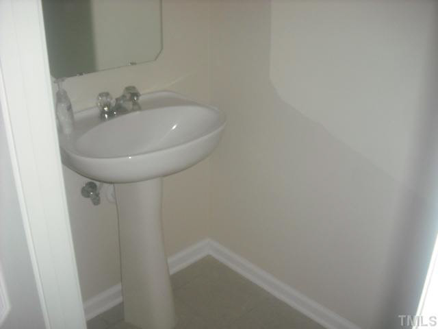 7663 Winners Edge Street Raleigh, NC 27617 - Photo 5 of 16 a bathroom with a sink and mirror