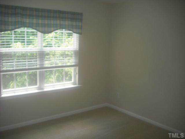 7663 Winners Edge Street Raleigh, NC 27617 - Photo 6 of 16 a view of empty room with window