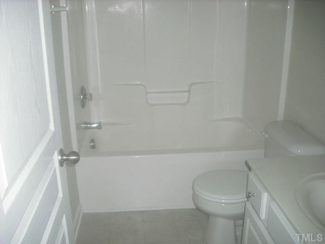 7663 Winners Edge Street Raleigh, NC 27617 - Photo 8 of 16 a bathroom with a shower and a toilet
