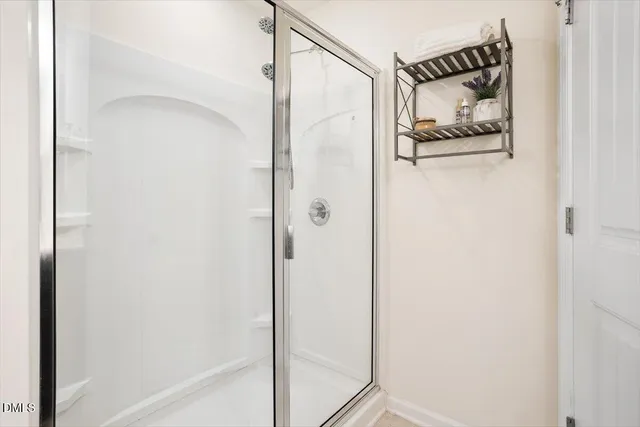 a bathroom with a shower and a sink