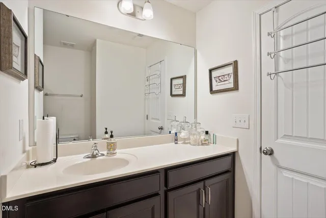 a bathroom with double vanity sinks and a mirror