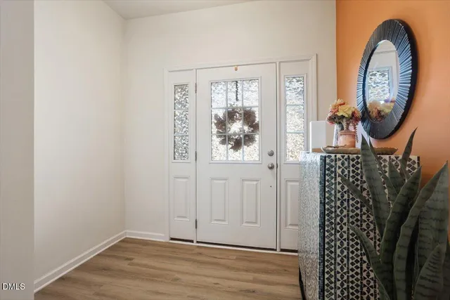 a view of a entryway door with wooden floor