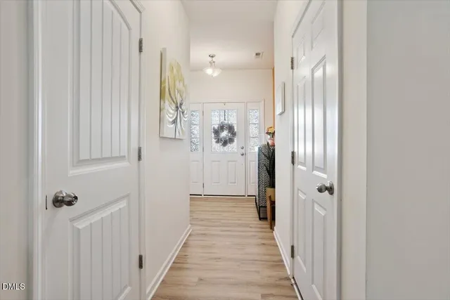 a view of a hallway with entryway door