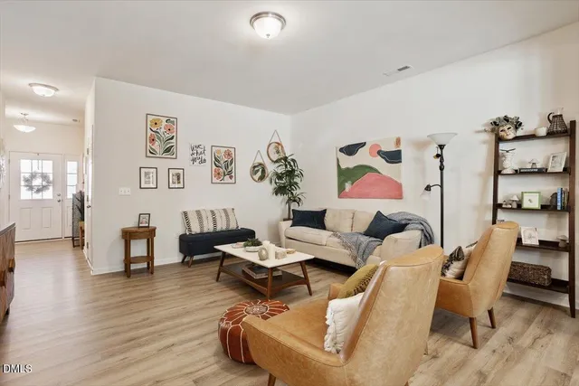 a living room with furniture and wooden floor