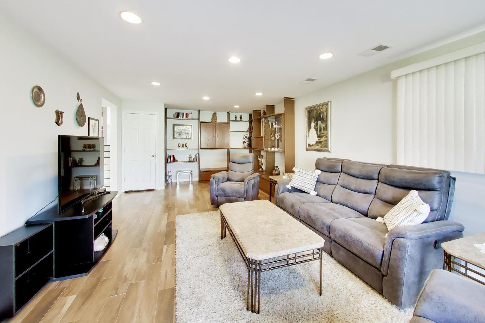 634 West Millers Road Des Plaines, IL 60016 - Photo 24 of 42 a living room with furniture and a flat screen tv