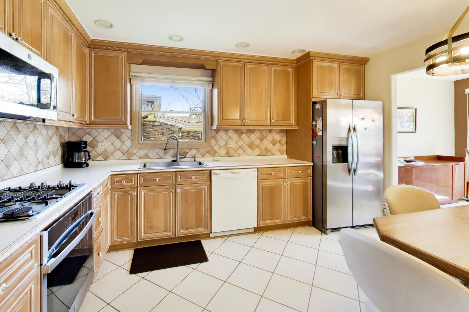 634 West Millers Road Des Plaines, IL 60016 - Photo 9 of 42 a kitchen with a refrigerator a stove a sink and dishwasher