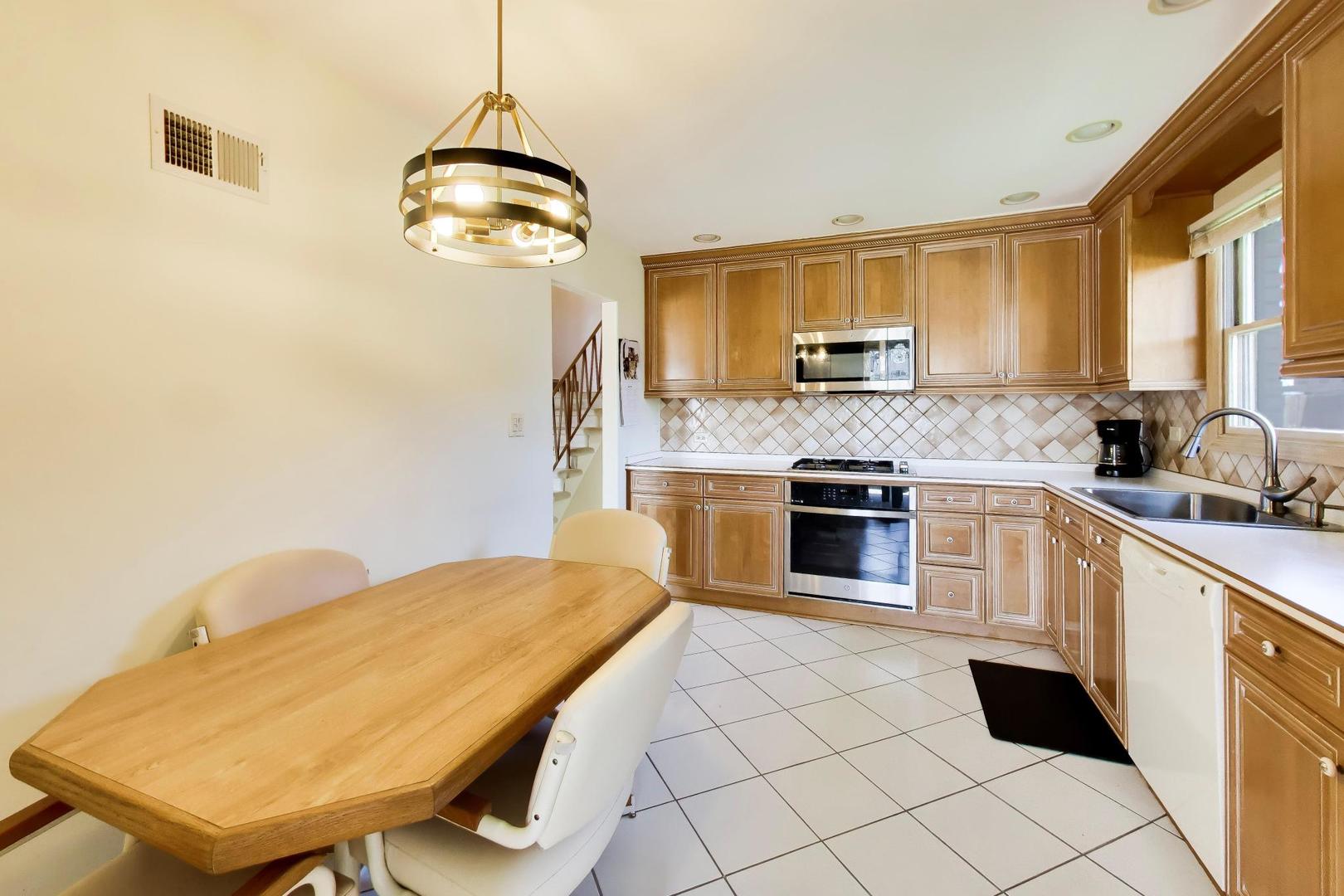 634 West Millers Road Des Plaines, IL 60016 - Photo 10 of 42 a kitchen with stainless steel appliances granite countertop a stove a sink and a refrigerator