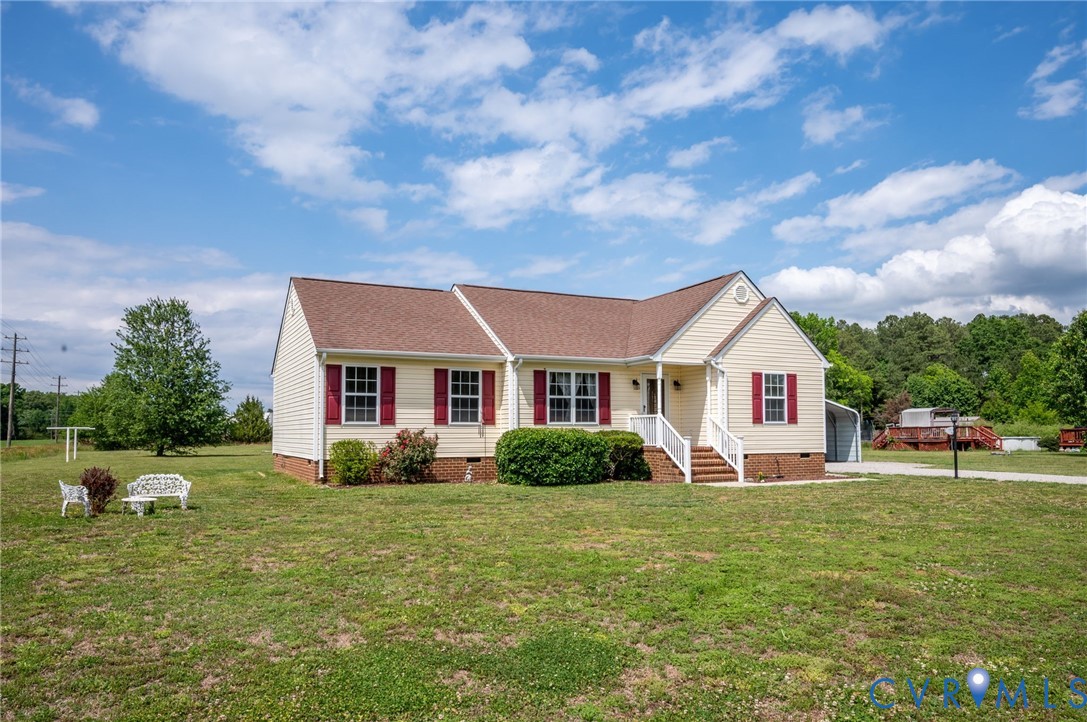 5280 West Quaker Road Disputanta, VA 23875 - Photo 3 of 33 a front view of a house with garden