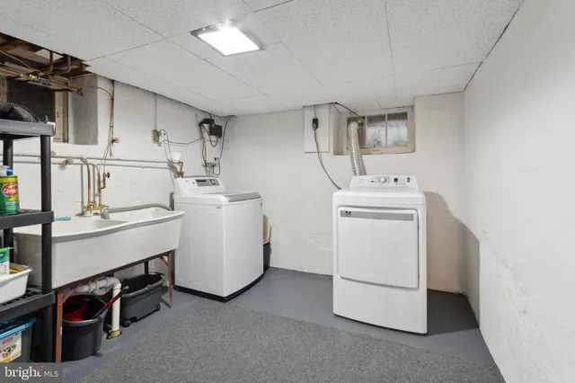 a utility room with cabinets dryer and washer