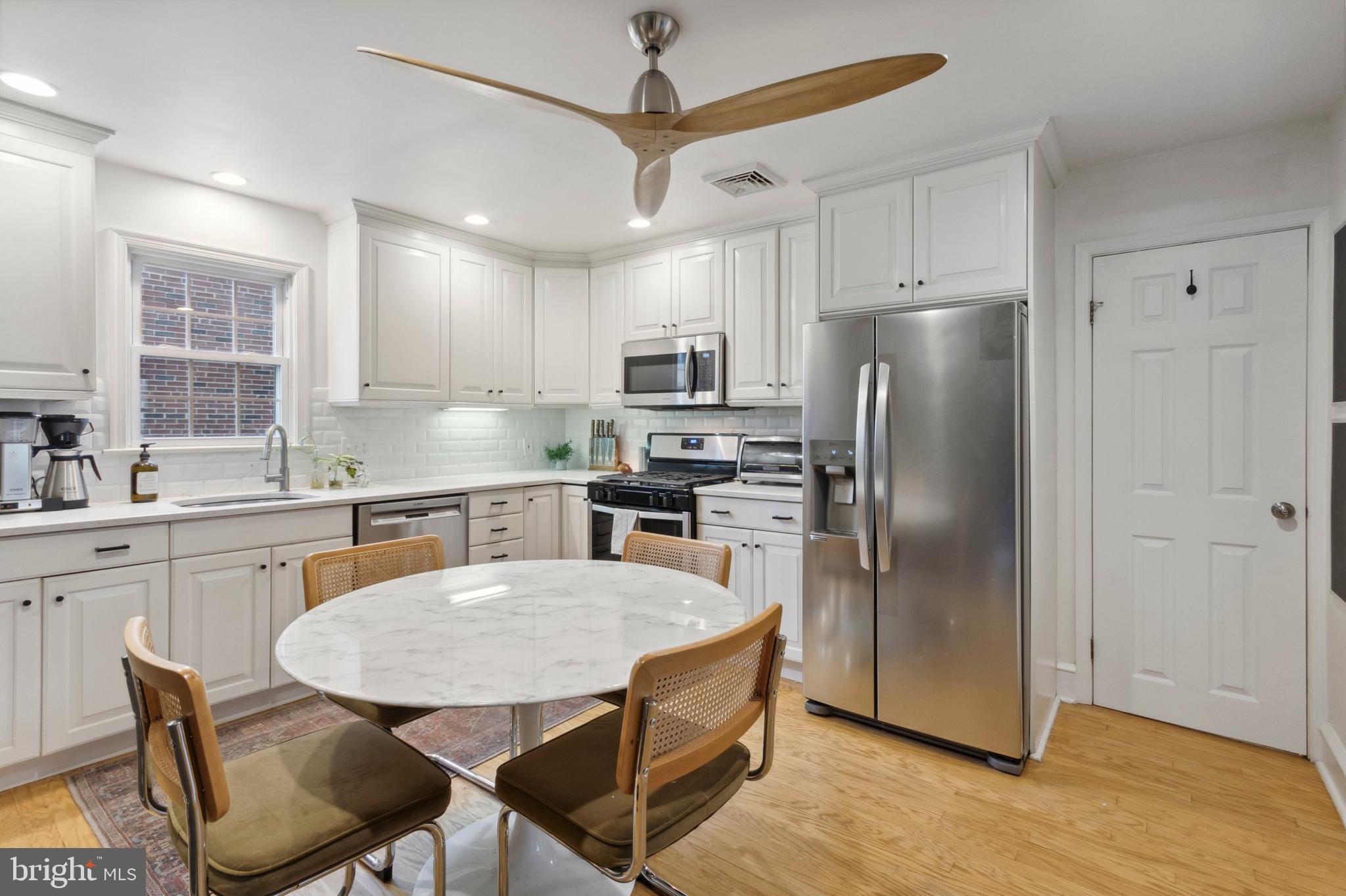 1420 Lawndale Road Havertown, PA 19083 - Photo 4 of 15 a kitchen with stainless steel appliances granite countertop a refrigerator a sink a stove a dining table and chairs