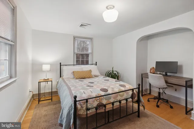 a bedroom that has a bed and a table in it