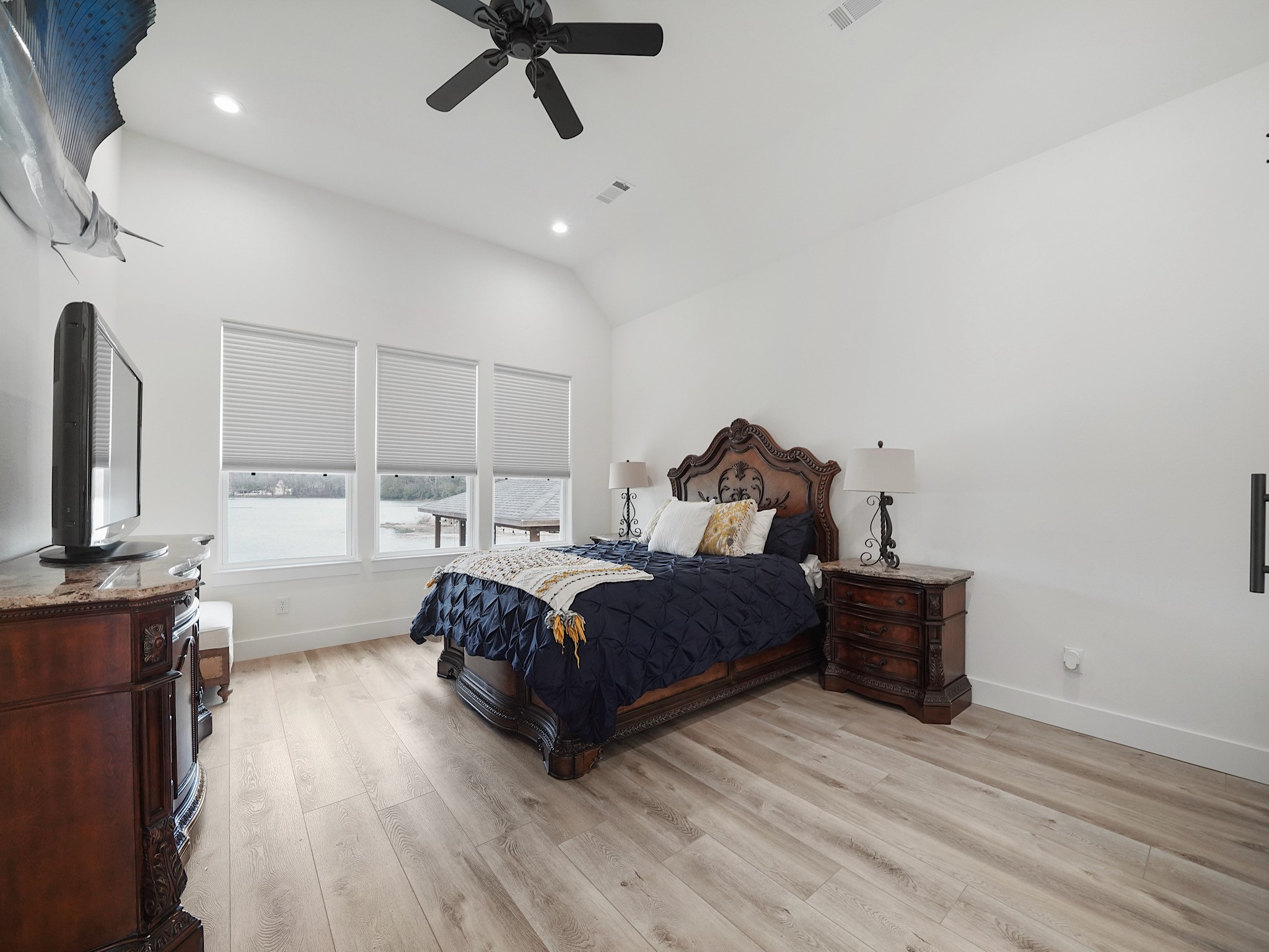 89 Cypress Bend Huntsville, TX 77340 - Photo 16 of 38 Primary bedroom with large windows and lovely views of the lake