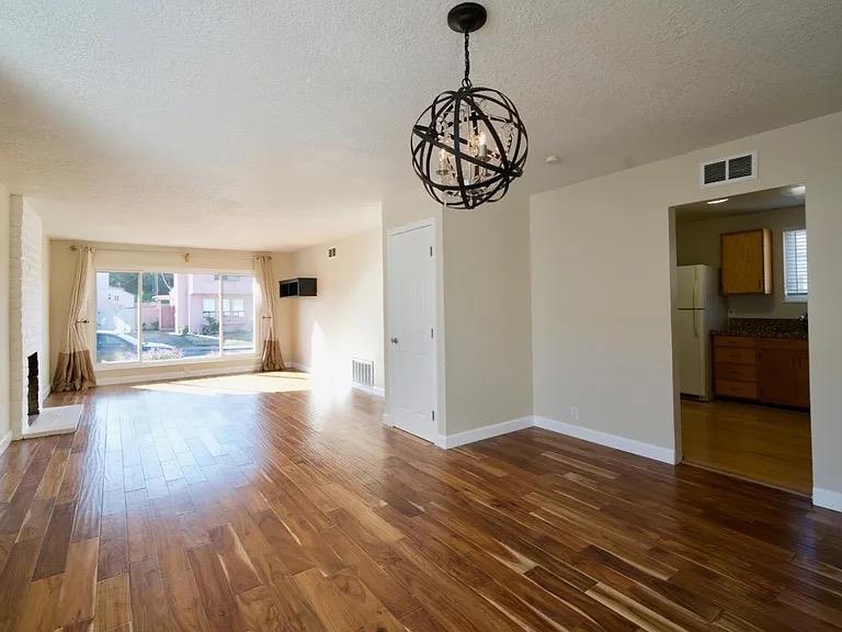 621 Forest Lake Drive Pacifica, CA 94044 - Photo 13 of 18 a view of an empty room with wooden floor