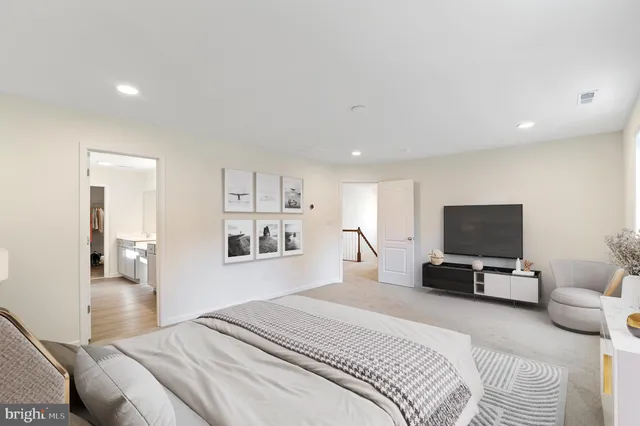 a bedroom with a bed and flat screen tv