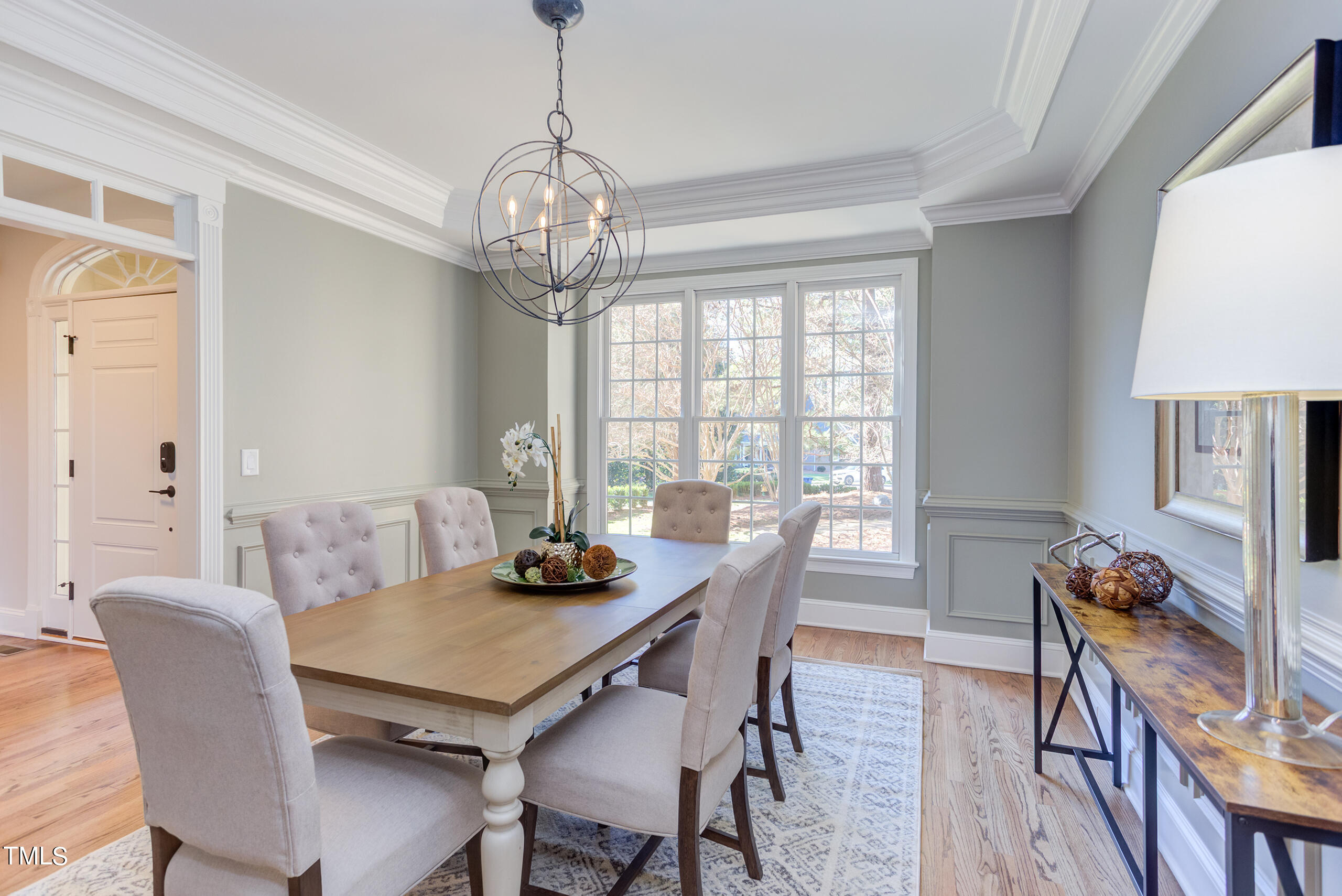 737 Loch Highlands Drive Raleigh, NC 27606 - Photo 12 of 85 a view of a dining room with furniture a chandelier and wooden floor