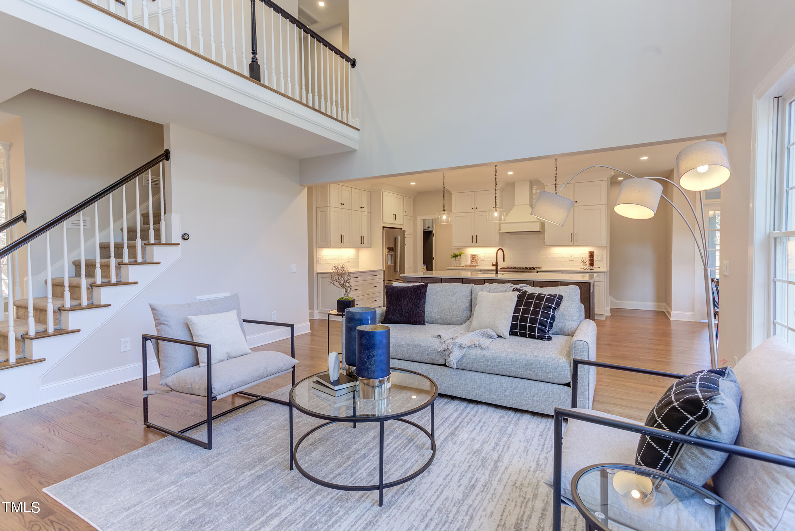 737 Loch Highlands Drive Raleigh, NC 27606 - Photo 18 of 85 a living room with furniture kitchen view and a wooden floor