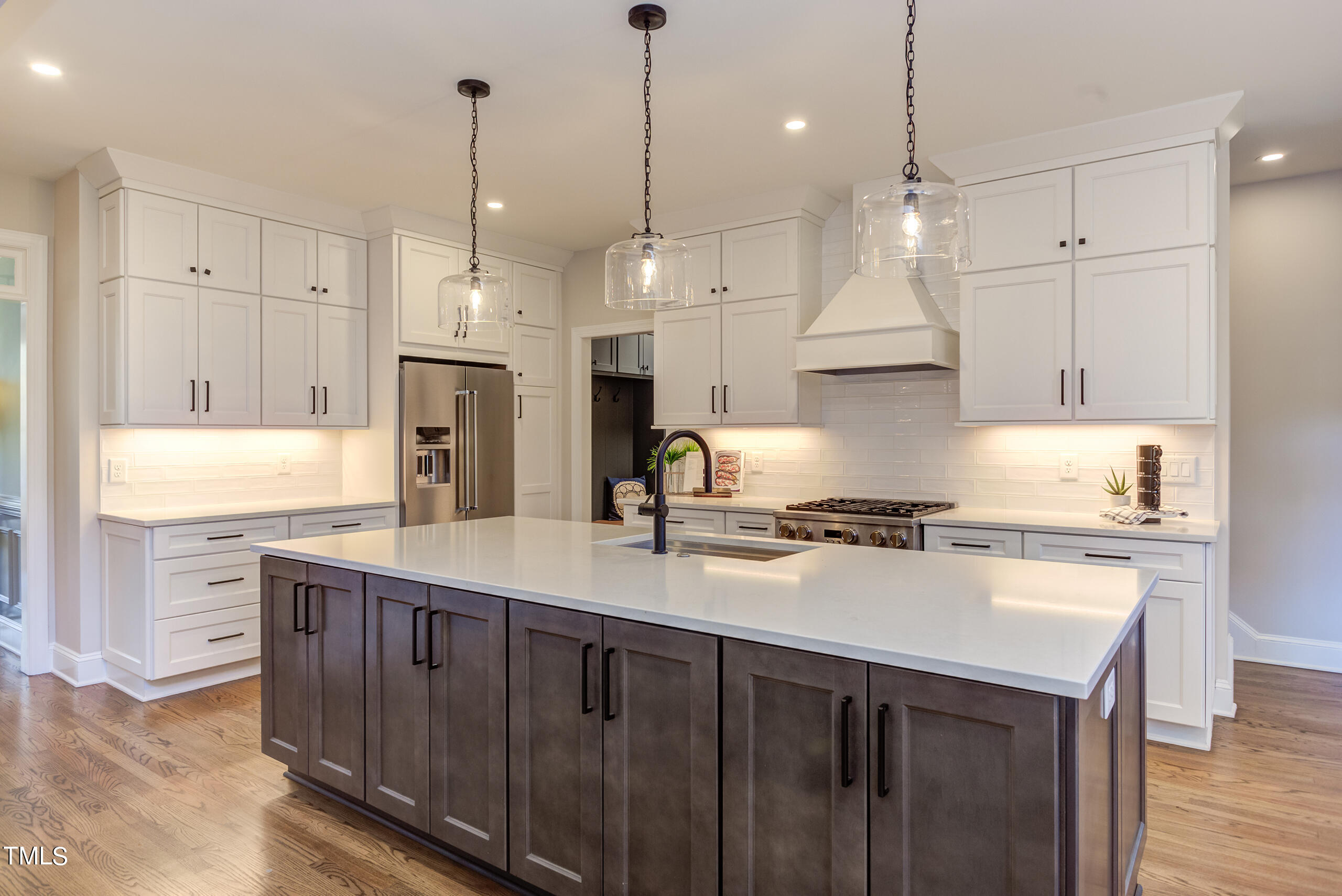 737 Loch Highlands Drive Raleigh, NC 27606 - Photo 22 of 85 a kitchen with stainless steel appliances granite countertop a sink a stove a refrigerator a center island and stove