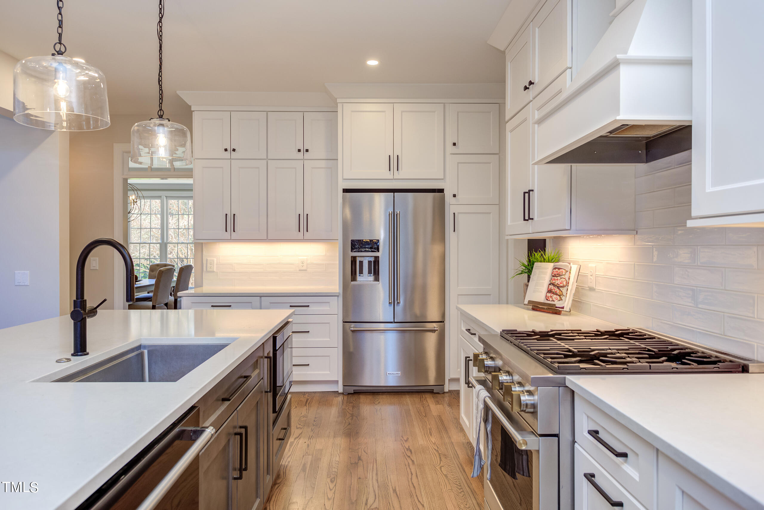 737 Loch Highlands Drive Raleigh, NC 27606 - Photo 25 of 85 a kitchen with stainless steel appliances granite countertop a sink stove and refrigerator