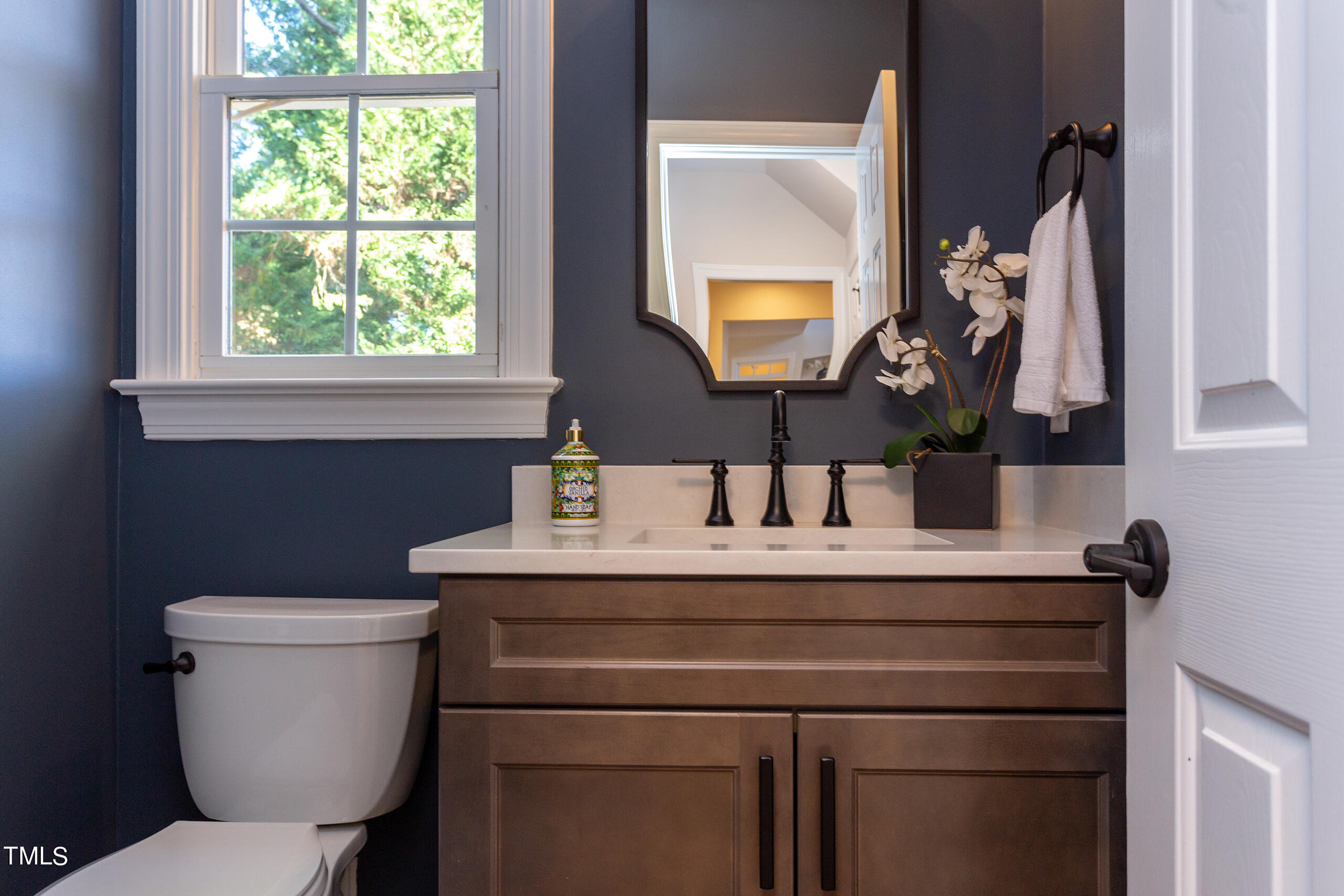 737 Loch Highlands Drive Raleigh, NC 27606 - Photo 27 of 85 a bathroom with a toilet sink and mirror